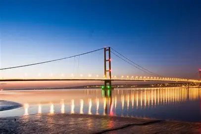 Illuminated bridge at sunset